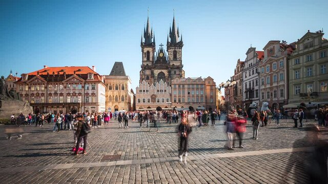 Timelapse view of people at the Old Town Square including historical landmark Church of Our Lady Before Tyn by day in fall season. 