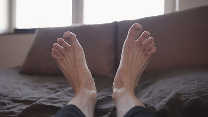 pov shot of man feet stretching in the morning - obrazy, fototapety, plakaty