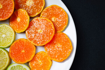 Naklejka na ściany i meble citrus fruit cut on a white plate
