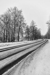 Winter road track. Black and white photo. Snow-covered track - 409445990
