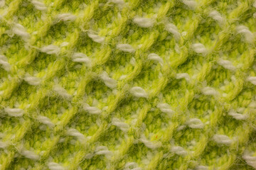 Green colored woven cloth macro close up top view square pattern weave