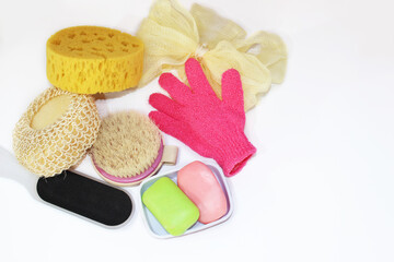 Bathroom accessories on a white background. Washcloths, sponges, brush, file, gloves, mesh and soap.