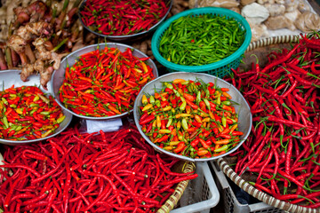 Colourful fresh chillies for sale in a market.