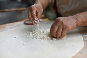 Turkish Food. Gozleme (Turkish stuffed flatbread) cooking process in traditional style. Adding cheese feta