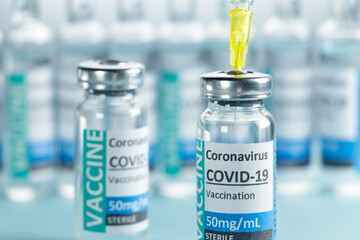 Covid-19 Corona Virus 2019-ncov vaccine vials medicine drug bottles syringe injection blue nitrile surgical gloves. Vaccination, immunization, treatment to cure Covid 19