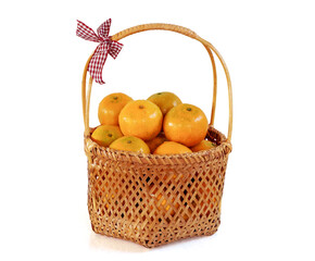Fresh Sweet Green oranges in fruit basket with red ribbon decorative isolated on white background with clipping path