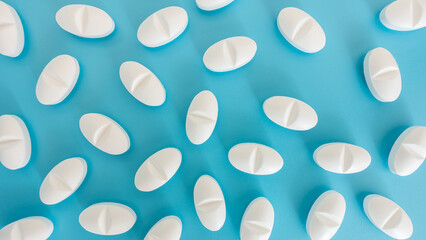 White pills pattern on a blue background.