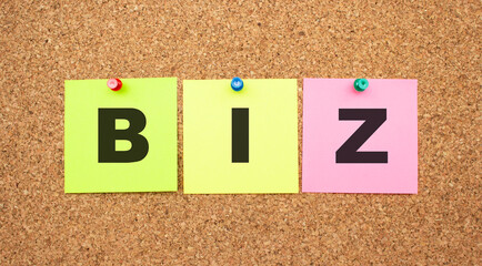 Color notes with letters pinned on a board. Word BIZ.
