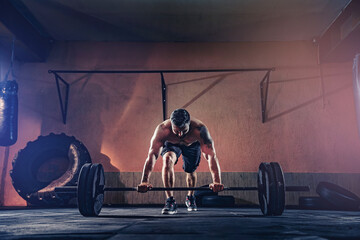 Muscular fitness man doing push a barbell over his head in his garage, selfisolation. Functional...