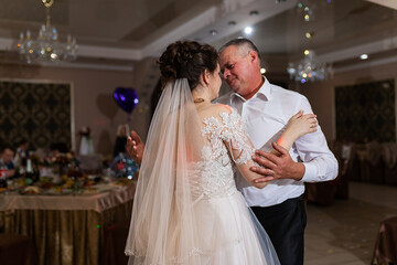 Naklejka premium just got married, two lovers dance a slow dance at a wedding, a romantic celebration in a restaurant in elegant suits