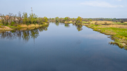 quiet summer river among green fields, summer rural landscape