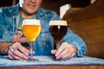 Golden ale and a dark stout beer are served in special glasses