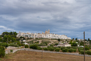 View of the skyline of Locortondo in Puglia from an olive tree field