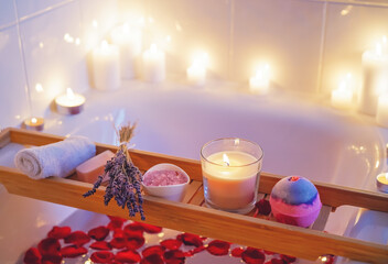 Spiritual aura cleansing flower bath for full moon ritual with bath bomb, candles, aroma salt, lavender and rose petals. Body care and mental health routine.