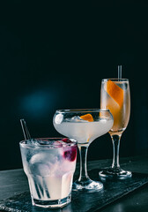 set with different cocktails on dark background