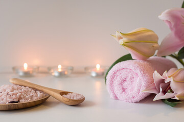 Obraz na płótnie Canvas Rose sea salt, candles, towels and lily flower