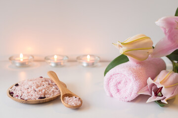 Rose sea salt, candles, towels and lily flower