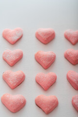 Naklejka na ściany i meble homemade pink cookies for valentine's day on a white background as a symbol of the holiday of all lovers.