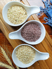 Jasmine rice, Brown rice, Red rice,Black rice, Mixed rice and Riceberry on Natural wood in the background,Top view,Vertical