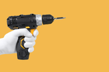 screwdriver in hand on a yellow background