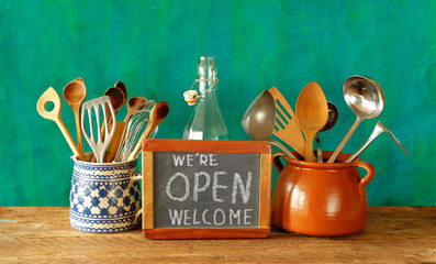 Welcome and open sign, restaurant or cafe ready to service after corona lockdown, hanging kitchen...