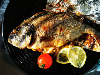 Baked fish in the oven with lemon