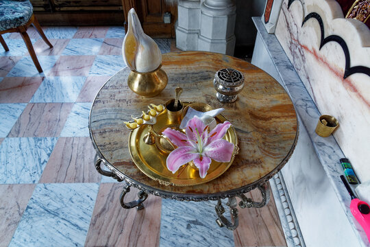 Puja lamp, flower, garland, conch, incense, water, handkerchief on a copper tray - hindu worship