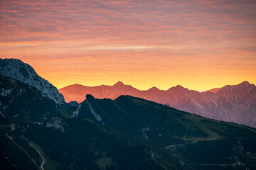 Fototapeta na wymiar Strong alp glow before sunset in the alps looks like the mountains are on fire