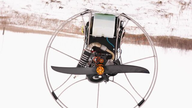 The Spinning of detail of propeller, motor, engine of the paramotor paraglider, Getting ready to fly off.