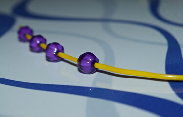 purple beads with yellowish object