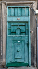 An old green rusty metal door