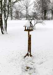 snowy bird feeder with seeds, Bird feeder in the winter snowy garden, Winter time. Winter