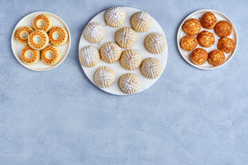 Arabic sweets. Traditional eid semolina maamoul or mamoul cookies with dates , walnuts and pistachio nuts . Top view, copy space
