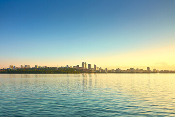 Fototapeta premium view of the city from the water, city, travel, tourism, architecture, cityscape, building, evening, skyline, sea, sky, landmark, downtown, beach, sunset, vacation, building, embankment, river, pier, l