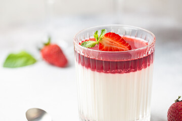 Italian panna cotta dessert with strawberry sirup and mint leaf