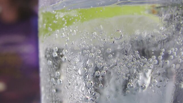 Cold and refreshing glass of sparkling water...with a slice of lime. Closeup. Macro shot.