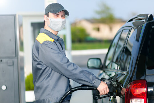 Gas Station Attendant At Work While Wearing A Mask