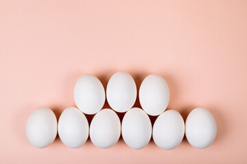 Easter eggs white on a pink background with place for text.