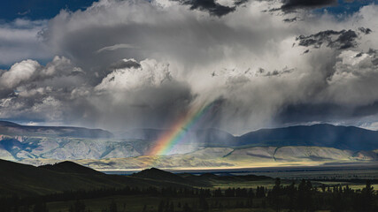 clouds and rainbow over the mountains