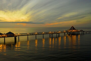 sunset at a pier on the beach