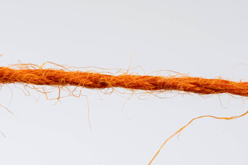 red fibrous rope against white background