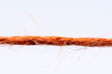 red fibrous rope against white background