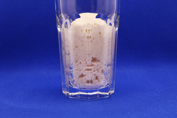 Wheat natural leaven for bread in a glass jar. The concept of a healthy diet. Sourdough starter. A living product. Grains. Selective focus.