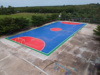 top view field futsal among forest sport outdoor white and green line aerial drone above the sky
