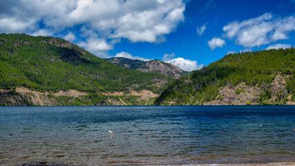 Landscape of lake Lacar, San martin de los Andes, Neuquen, Argentina. Taken on a warm summer afternoon under a ble sky with a few white clouds           