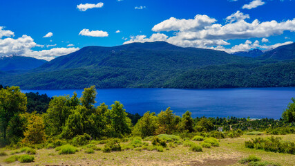 Fototapeta na wymiar Landscape of lake Lacar, San martin de los Andes, Neuquen, Argentina. Taken on a warm summer afternoon under a ble sky with a few white clouds 