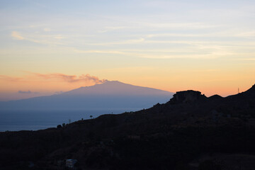 sunset over a smoking volcano in Italy