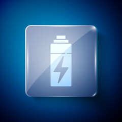 White Battery icon isolated on blue background. Lightning bolt symbol. Square glass panels. Vector.
