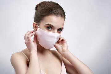 Woman in protective mask on white background