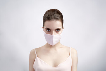 Woman in protective mask on white background